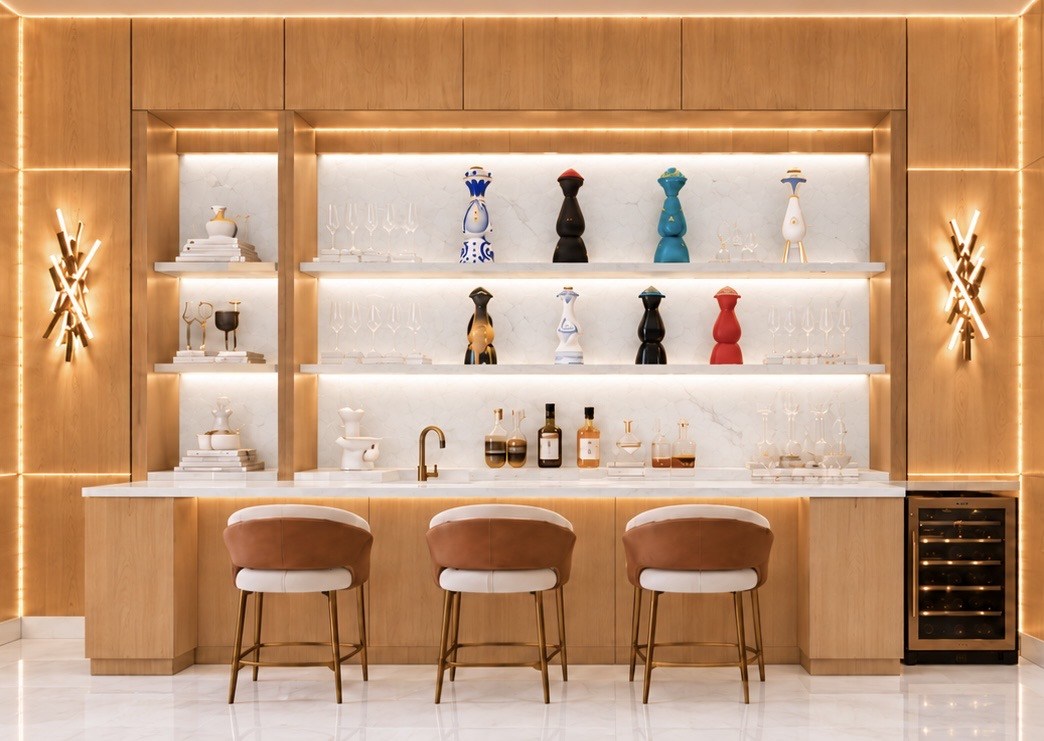 Bar with colorful sculptural accents and warm wood paneling