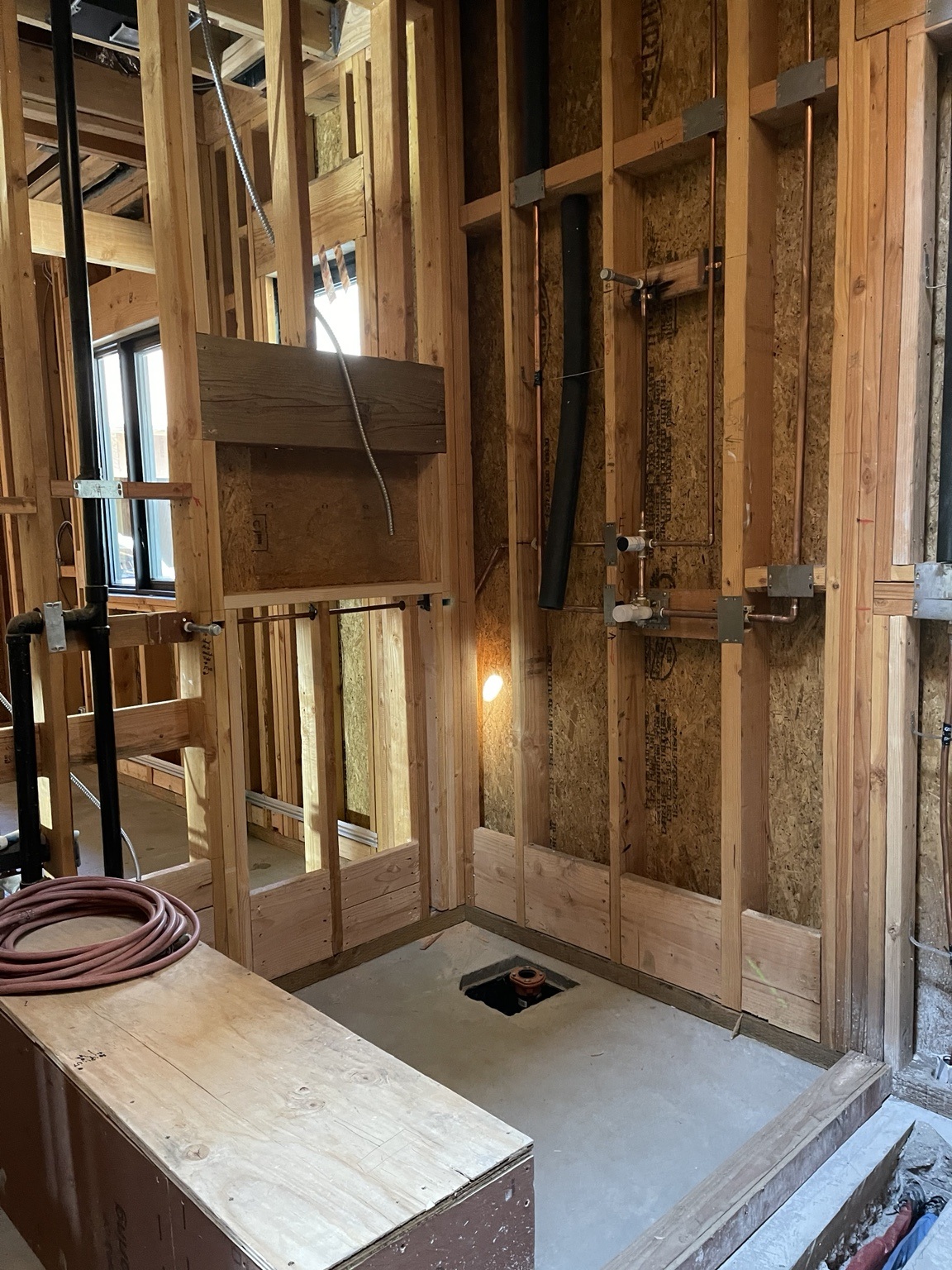 Bathroom framing and plumbing installation before finishes