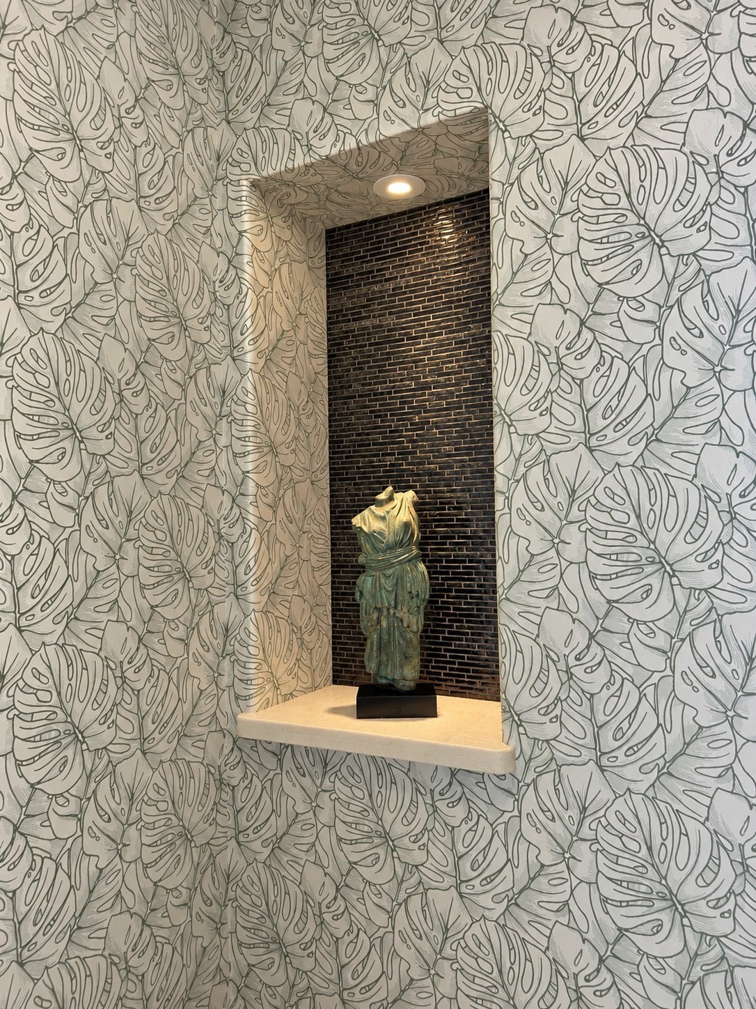 Powder room display niche with sculptural accent