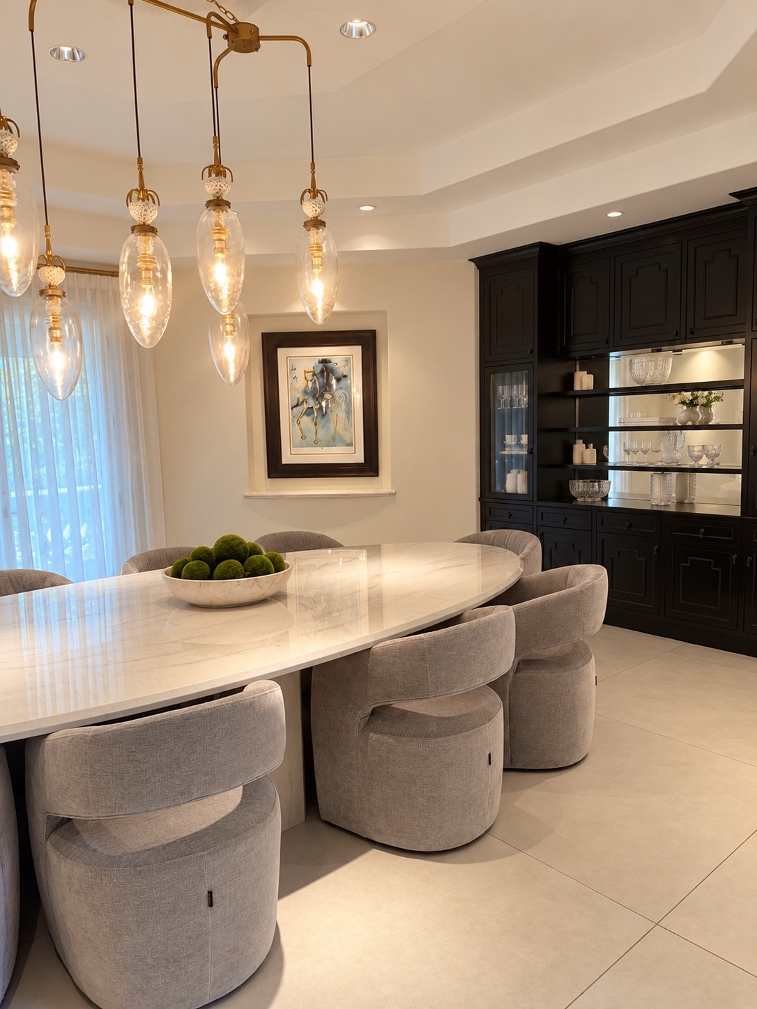 Dining room with oval table and dark display cabinetry