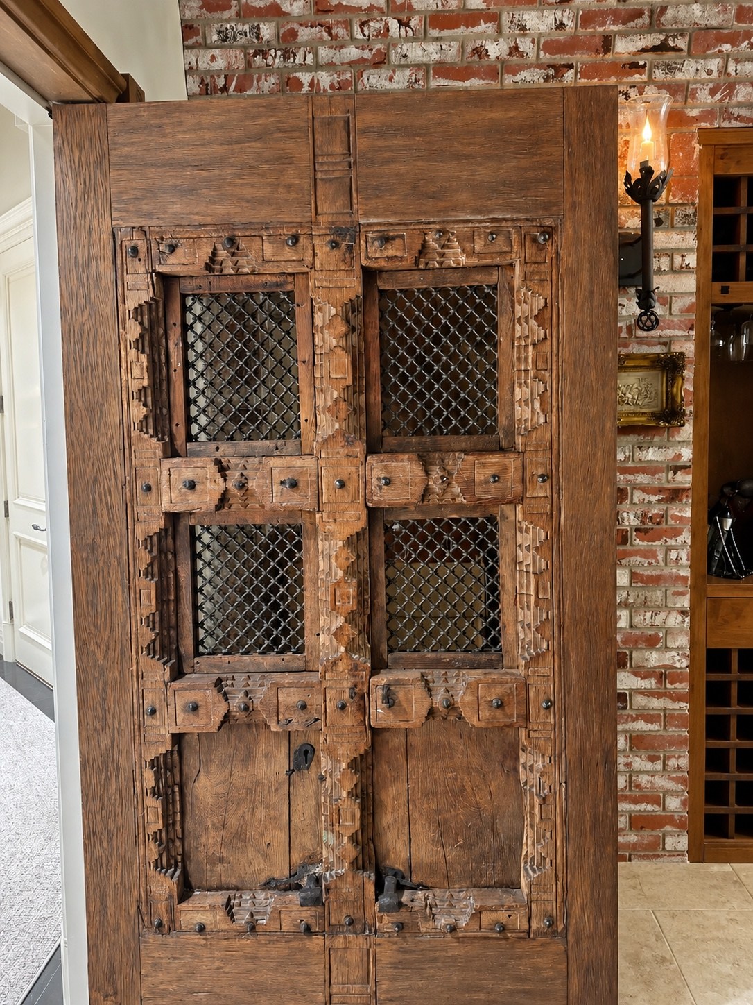 Carved wood doors with decorative metalwork