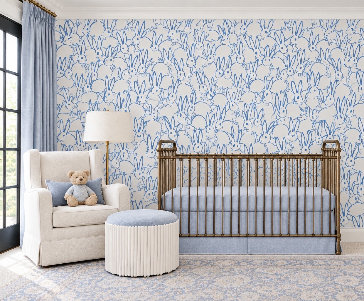 Nursery with blue patterned wallpaper and upholstered reading chair